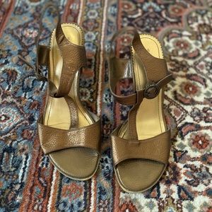 Gold shoes with wooden heel.